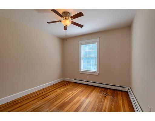 142 East Meadow Road Lowell, MA 01854 - Photo 15 of 28 an empty room with wooden floor and windows