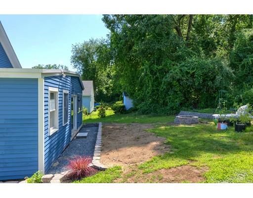 142 East Meadow Road Lowell, MA 01854 - Photo 27 of 28 a backyard of a house with lots of green space