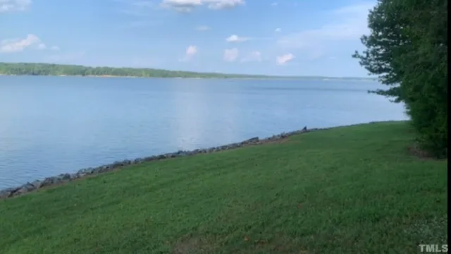 a view of a lake and green valley