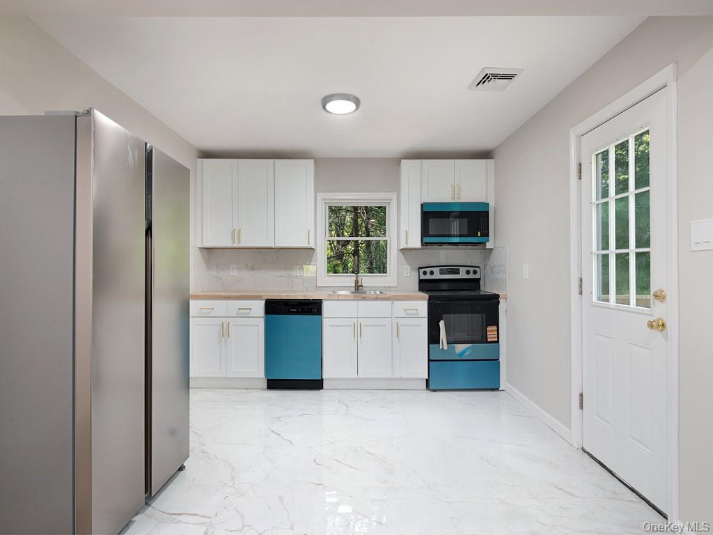 59 Corbin Road Dover Plains, NY 12522 - Photo 2 of 16 a kitchen with granite countertop a refrigerator and a stove top oven