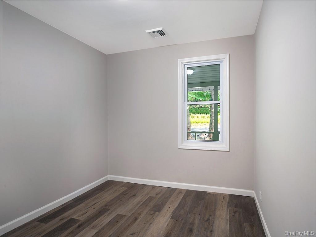59 Corbin Road Dover Plains, NY 12522 - Photo 7 of 16 a view of an empty room with wooden floor and a window