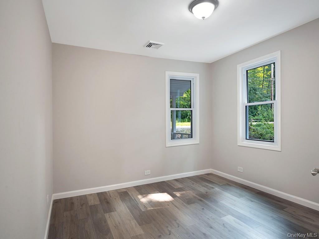 59 Corbin Road Dover Plains, NY 12522 - Photo 8 of 16 an empty room with wooden floor and windows