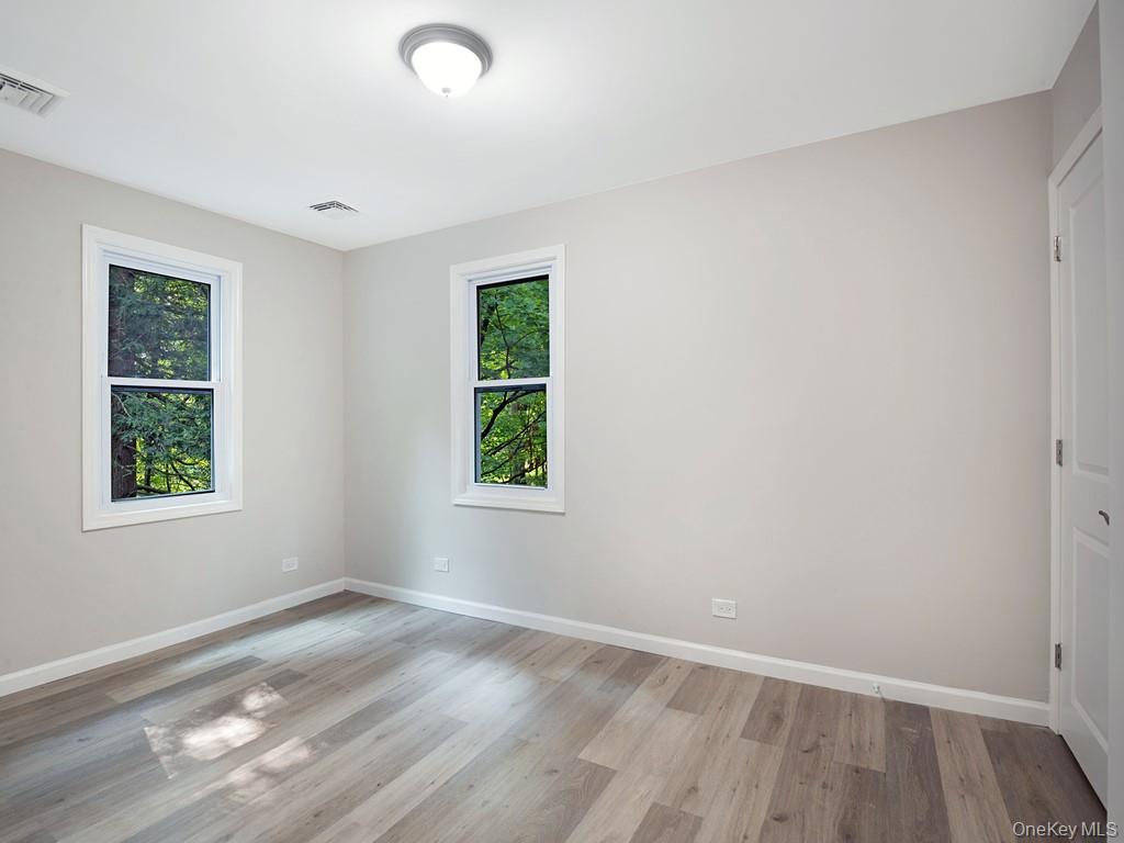 59 Corbin Road Dover Plains, NY 12522 - Photo 9 of 16 an empty room with wooden floor and windows