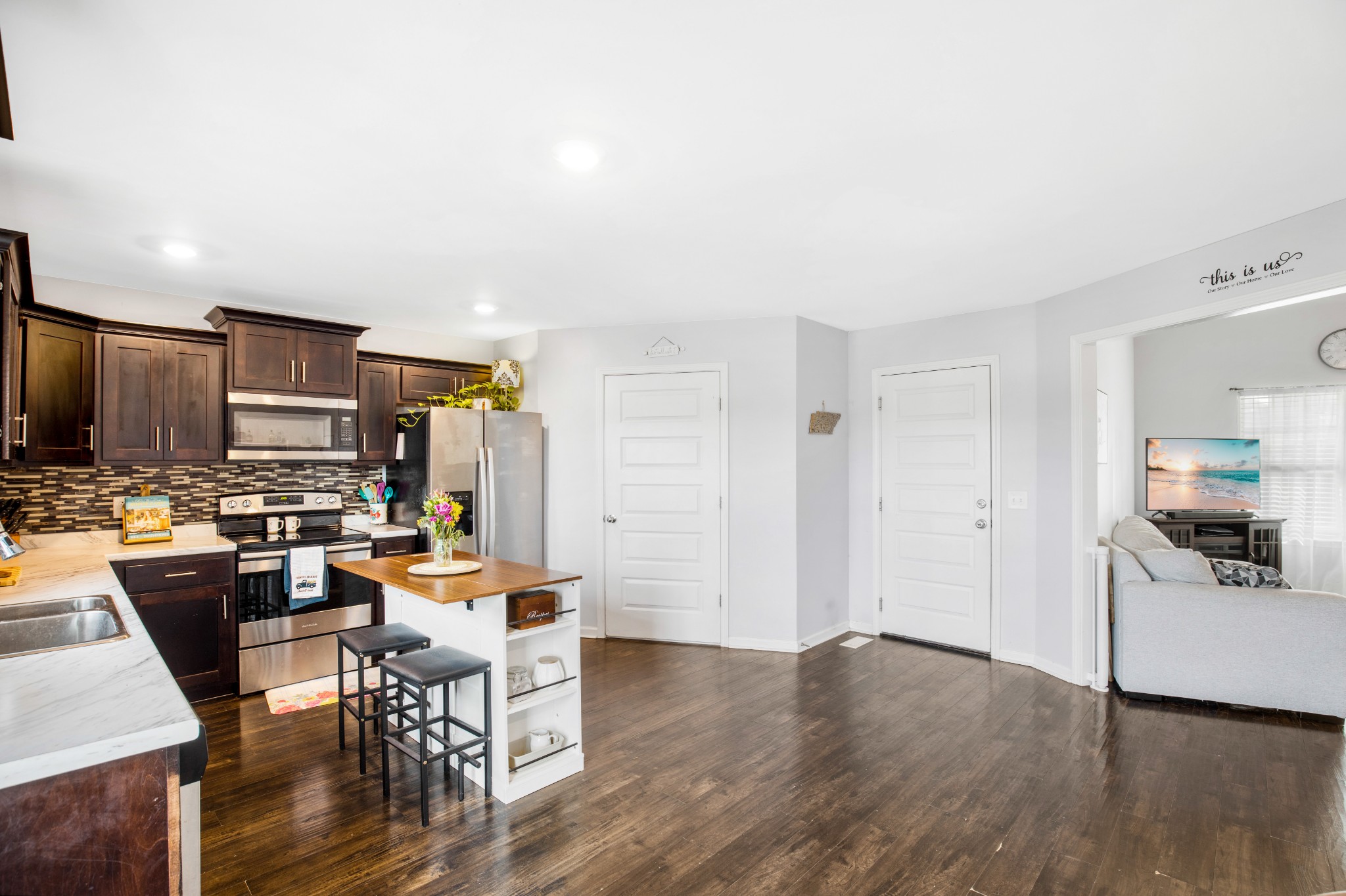 123 Sage Drive Springfield, TN 37172 - Photo 4 of 18 a view of a dining room with furniture a kitchen and chandelier