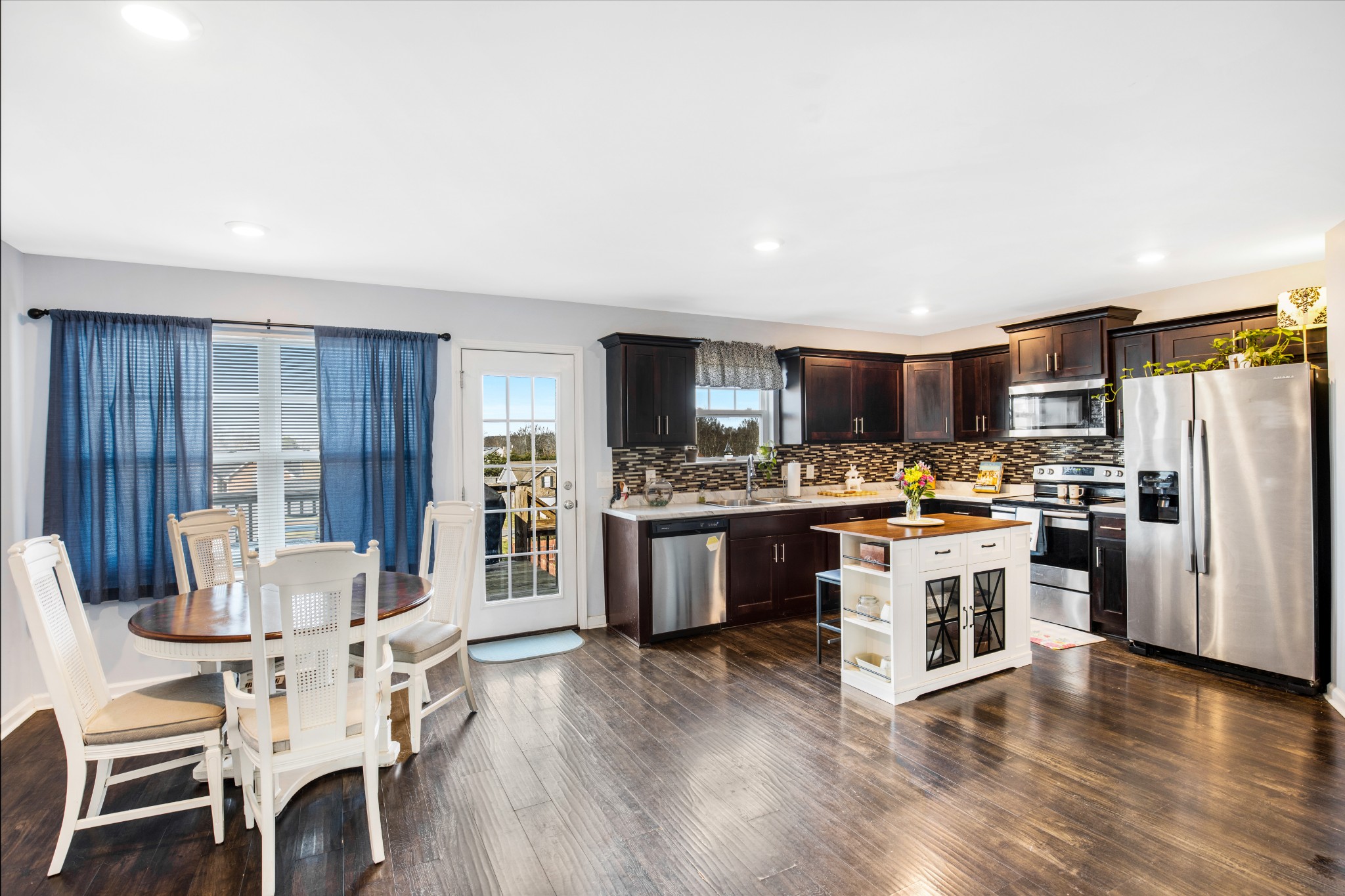 123 Sage Drive Springfield, TN 37172 - Photo 5 of 18 a kitchen with stainless steel appliances kitchen island granite countertop a refrigerator a stove top oven a sink dishwasher and white cabinets with wooden floor