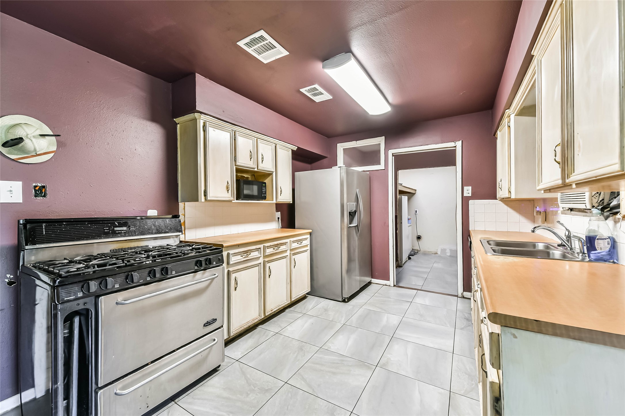 10438 Caxton Street Houston, TX 77016 - Photo 20 of 24 a kitchen with stainless steel appliances granite countertop a stove a sink and a refrigerator