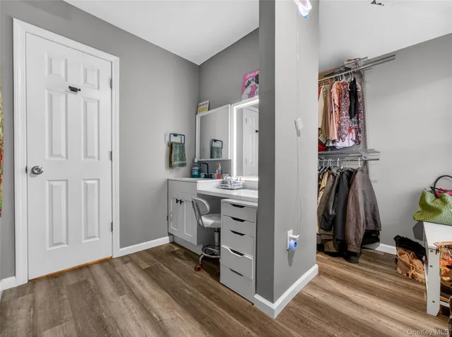 a view of walk in closet with clothes and shoes