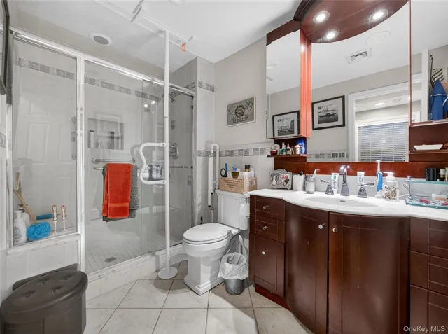 a spacious bathroom with a granite countertop sink toilet and shower
