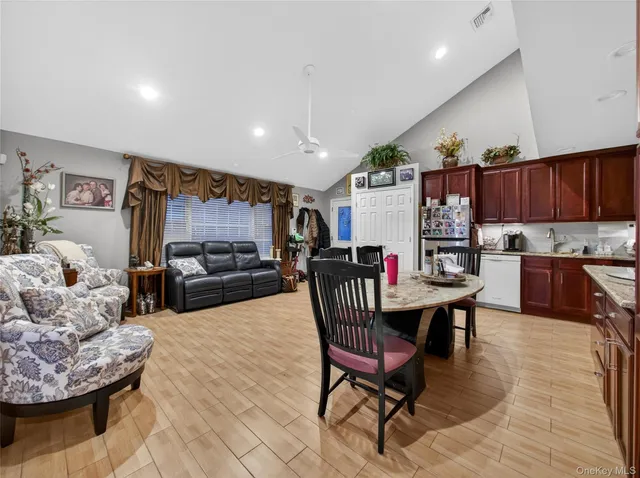 a living room with furniture and a dining table with kitchen view