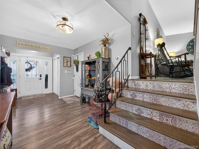 a view of entryway and hall with wooden floor