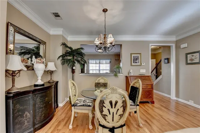 a view of a dining room with furniture and chandelier