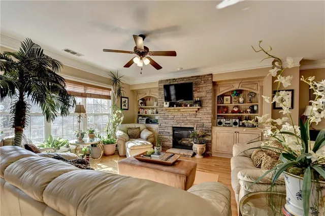 a living room with furniture fireplace and flat screen tv