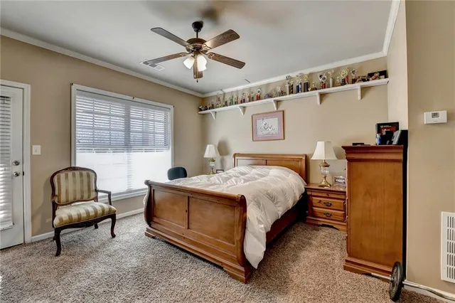 a bedroom with a bed couch and window