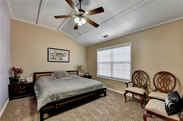 a bedroom with a bed furniture and a window