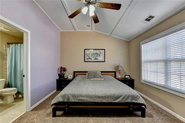 a bed sitting in a room next to a window