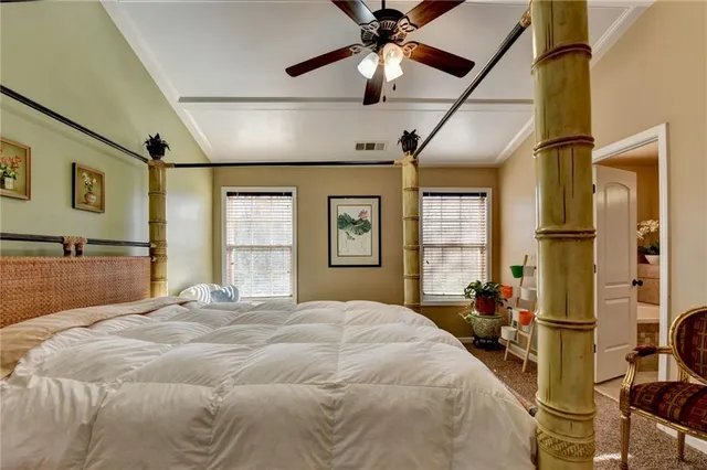 a bedroom with a large bed and a chandelier