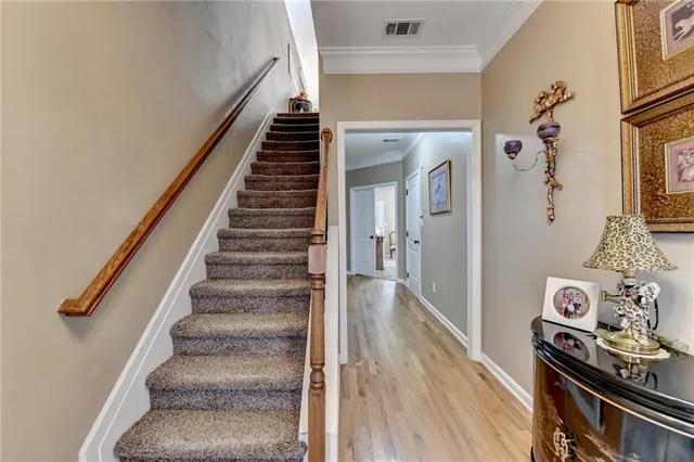 a view of a hallway with wooden floor and entryway