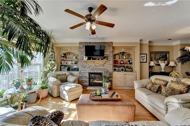 a living room with furniture fireplace and a flat screen tv