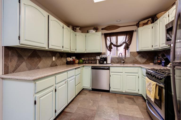637 Thomas Street Oak View, CA 93022 - Photo 12 of 30 a kitchen with granite countertop a sink a stove and cabinets
