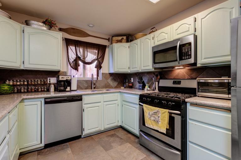 637 Thomas Street Oak View, CA 93022 - Photo 13 of 30 a kitchen with stainless steel appliances granite countertop a sink a stove and microwave
