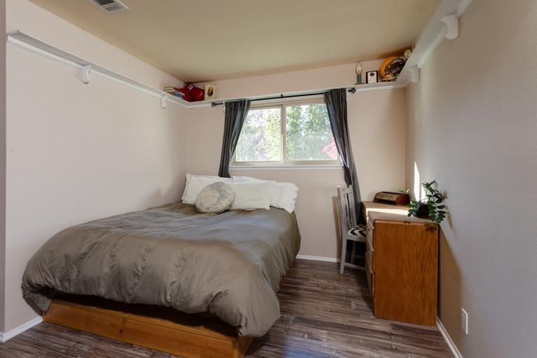 637 Thomas Street Oak View, CA 93022 - Photo 17 of 30 a bedroom with a bed and wooden floor