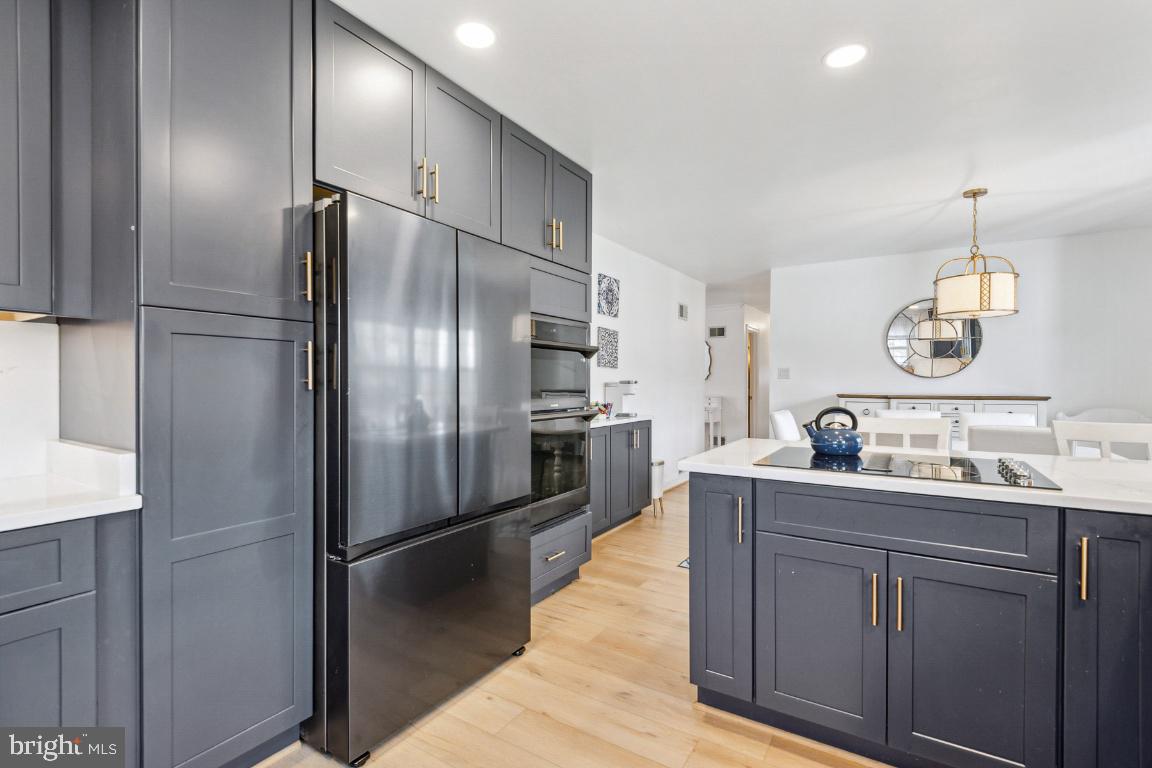 11213 Oakwood Drive Dunkirk, MD 20754 - Photo 13 of 48 a kitchen with kitchen island a counter top space cabinets and stainless steel appliances
