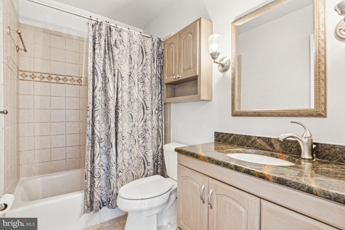 11213 Oakwood Drive Dunkirk, MD 20754 - Photo 21 of 48 a bathroom with a granite countertop sink toilet and shower