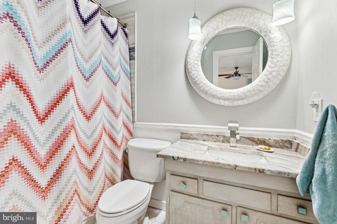 11213 Oakwood Drive Dunkirk, MD 20754 - Photo 24 of 48 a bathroom with a granite countertop sink and a mirror