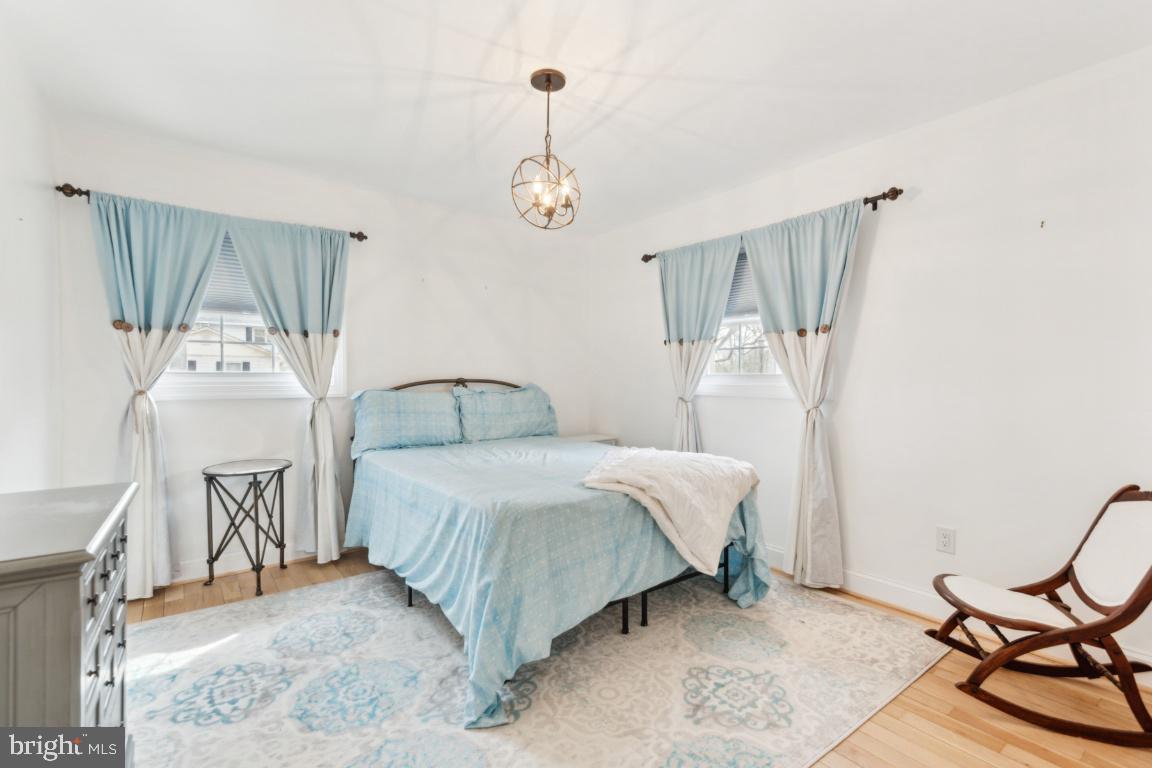 11213 Oakwood Drive Dunkirk, MD 20754 - Photo 26 of 48 a bedroom with a bed a chandelier and dresser