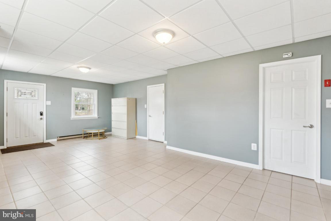 11213 Oakwood Drive Dunkirk, MD 20754 - Photo 30 of 48 an empty room with windows and wooden door