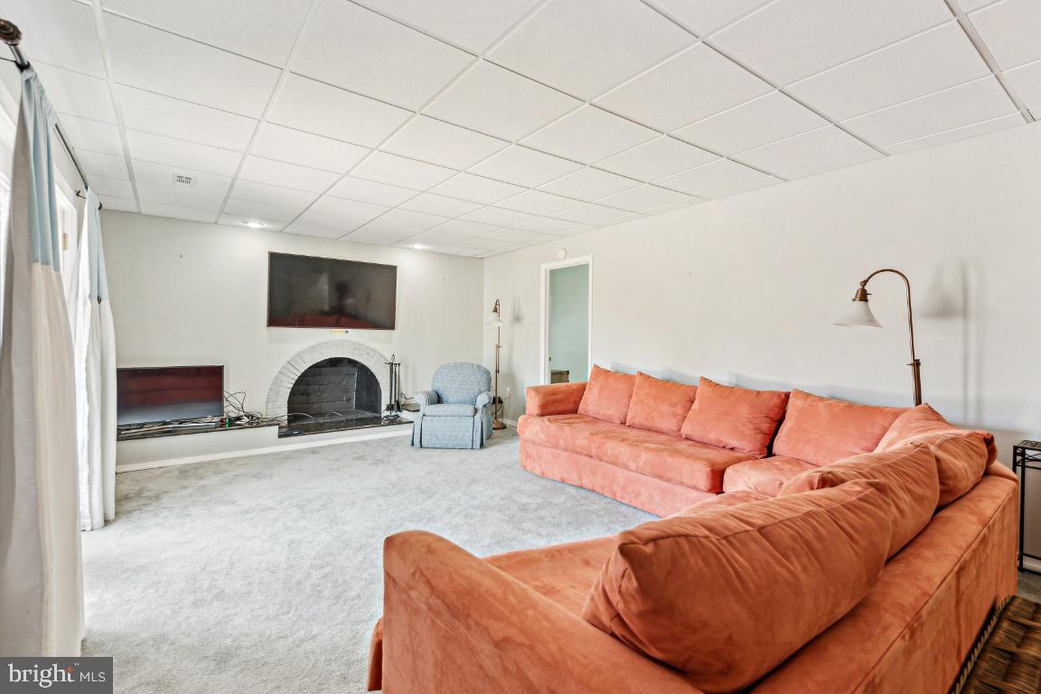 11213 Oakwood Drive Dunkirk, MD 20754 - Photo 35 of 48 a living room with furniture a flat screen tv and a fireplace