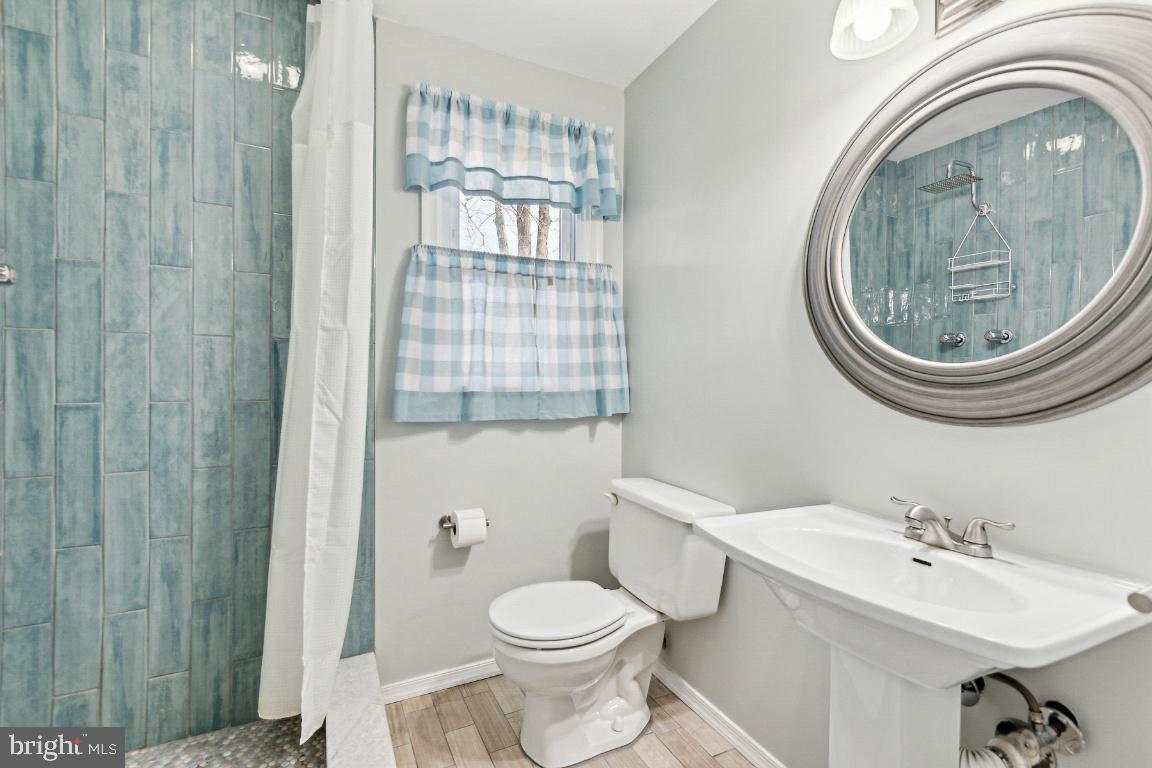 11213 Oakwood Drive Dunkirk, MD 20754 - Photo 37 of 48 a bathroom with a sink toilet and shower