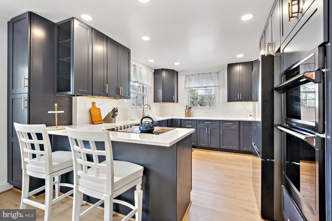 11213 Oakwood Drive Dunkirk, MD 20754 - Photo 9 of 48 a kitchen with a sink stainless steel appliances and dining table