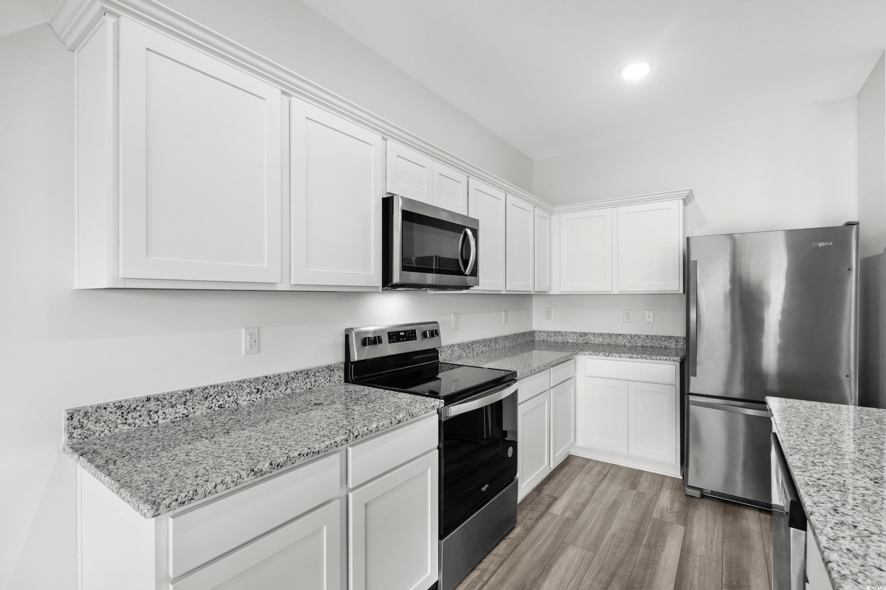 443 Castillo Drive Longs, SC 29568 - Photo 11 of 32 Kitchen with stainless steel appliances, white cabinets, light stone countertops, light wood-style floors, and recessed lighting