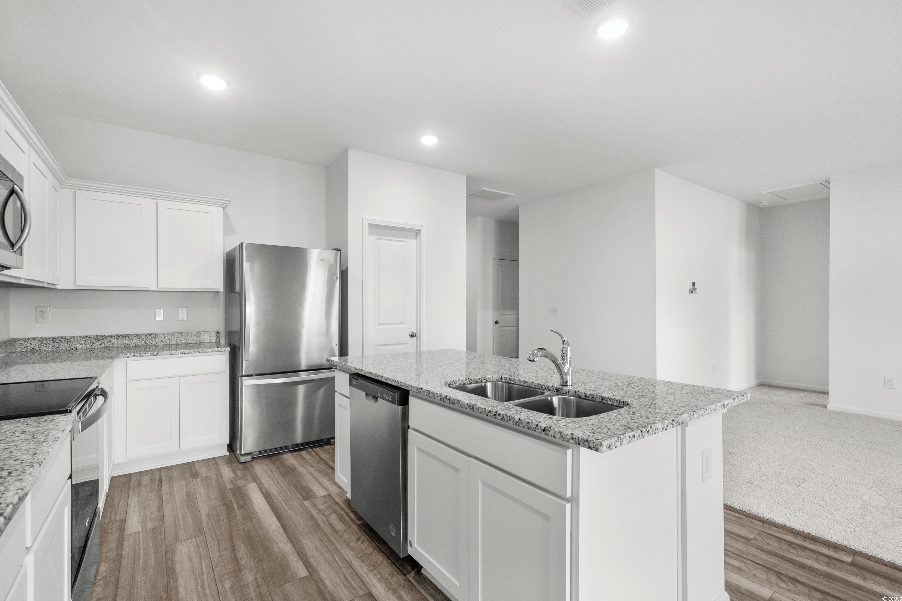 443 Castillo Drive Longs, SC 29568 - Photo 13 of 32 Kitchen with white cabinetry, appliances with stainless steel finishes, an island with sink, light stone countertops, and recessed lighting