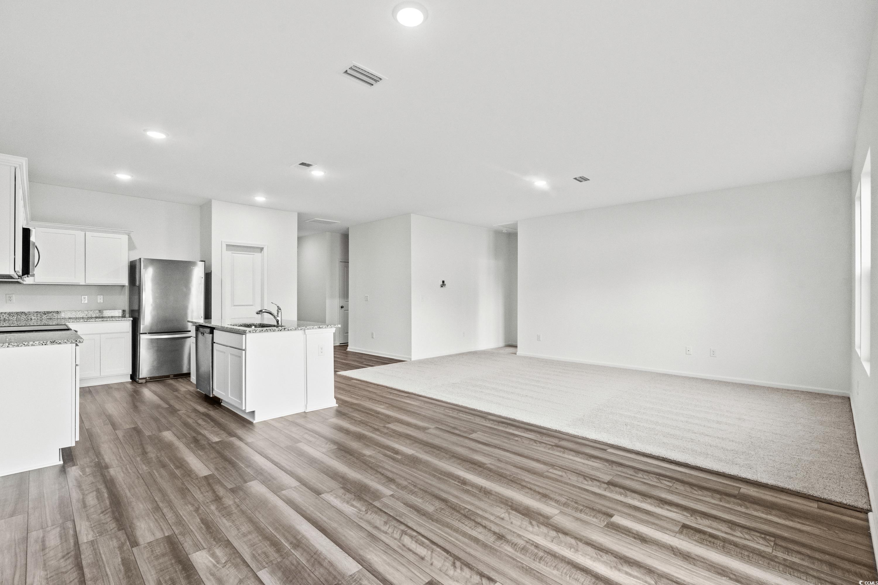 443 Castillo Drive Longs, SC 29568 - Photo 32 of 32 Kitchen with open floor plan, white cabinetry, stainless steel appliances, a kitchen island with sink, and recessed lighting