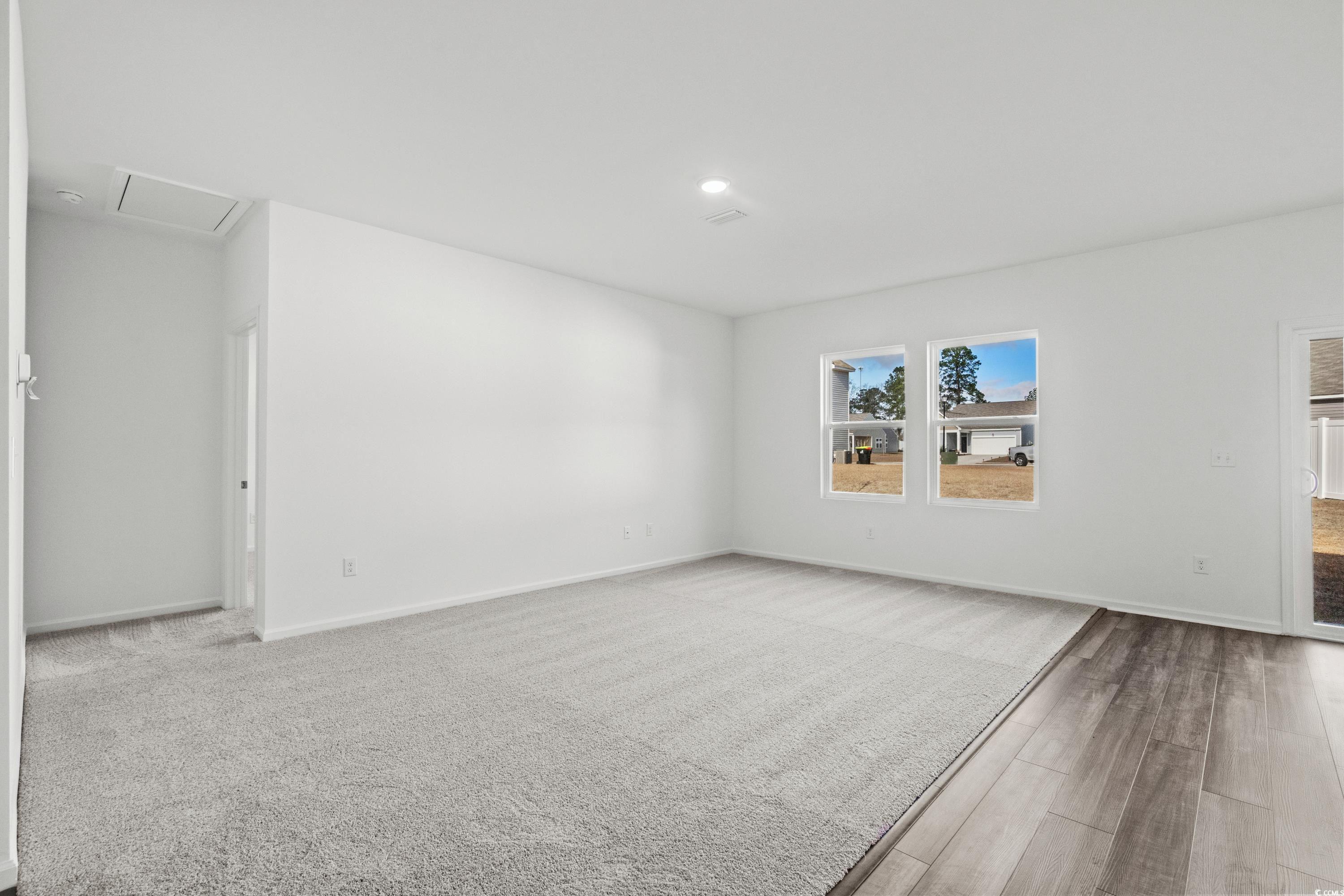 443 Castillo Drive Longs, SC 29568 - Photo 17 of 32 Spare room featuring wood finished floors and attic access