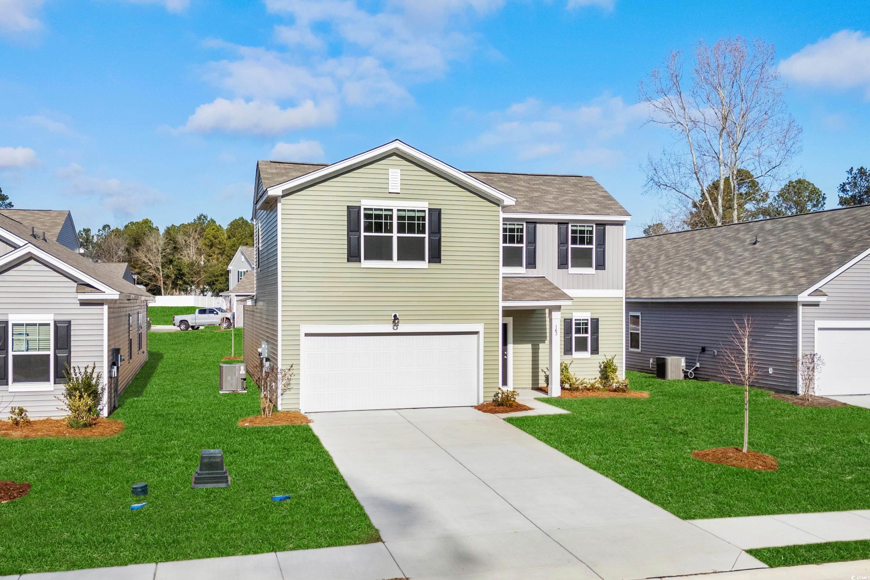 443 Castillo Drive Longs, SC 29568 - Photo 2 of 32 Traditional-style house with roof with shingles, a front lawn, concrete driveway, and a garage