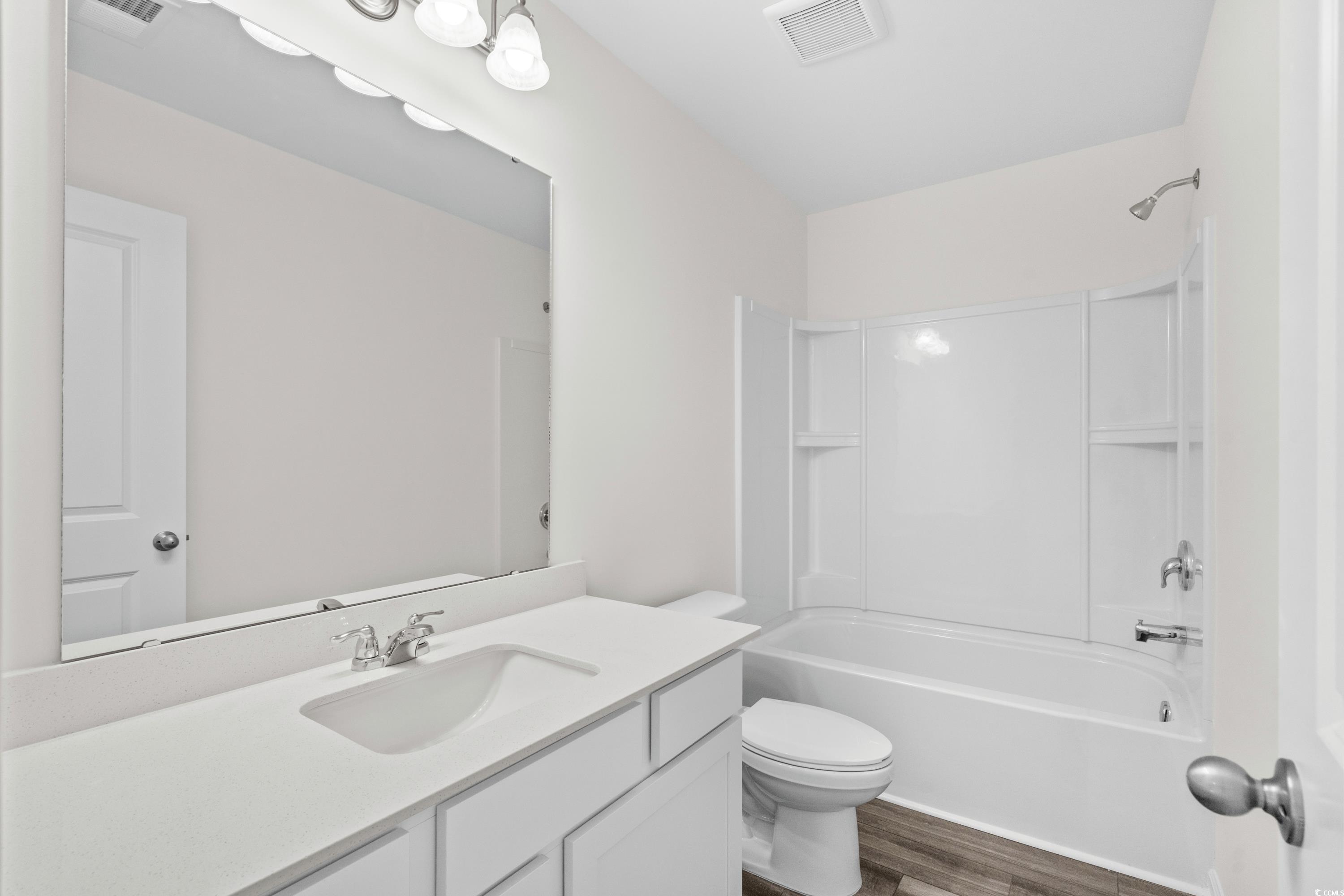 443 Castillo Drive Longs, SC 29568 - Photo 29 of 32 Full bath featuring bathing tub / shower combination, vanity, and dark wood-style flooring