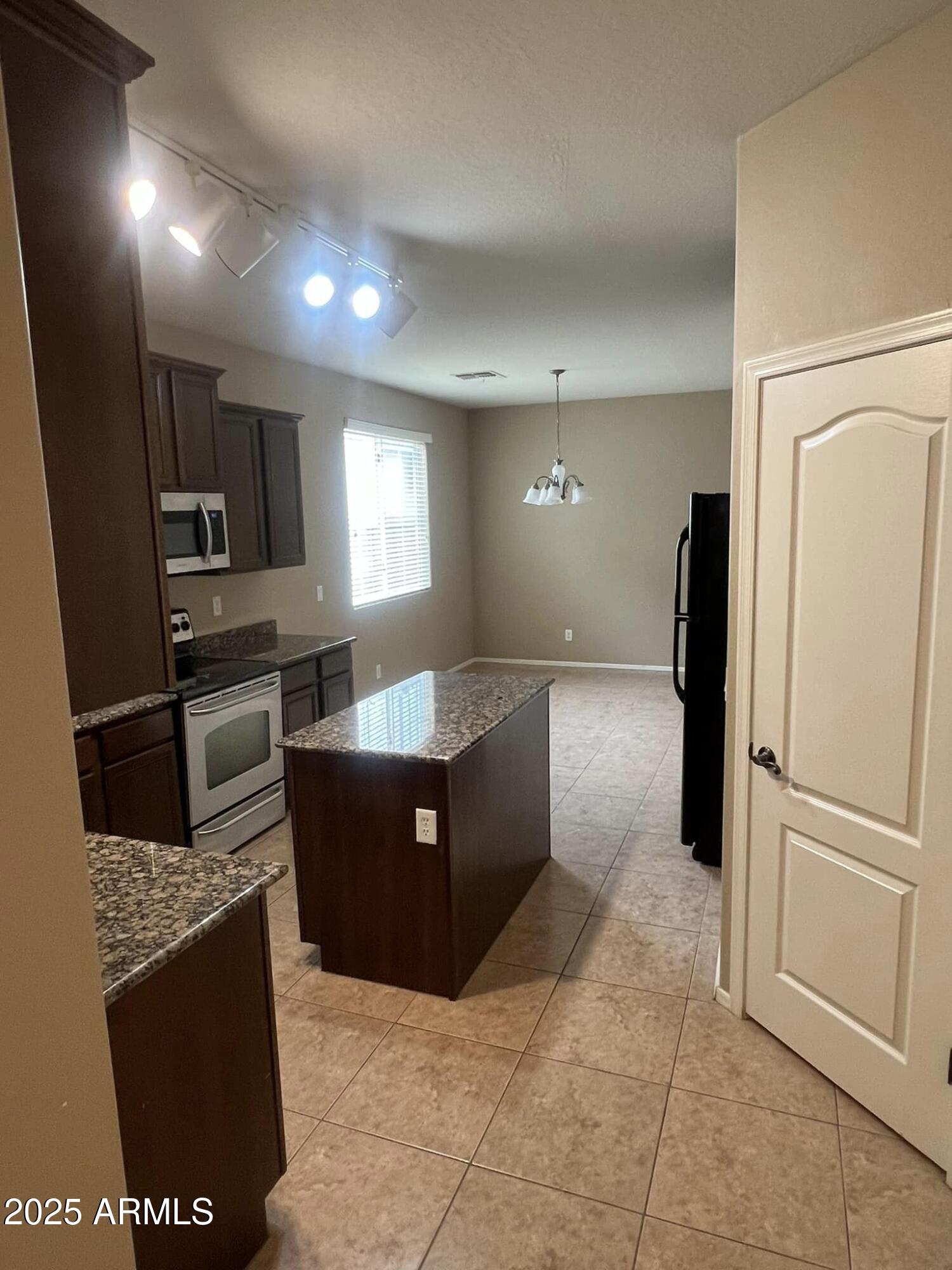 4265 East Milky Way Gilbert, AZ 85295 - Photo 13 of 33 a large kitchen with granite countertop a refrigerator and a sink
