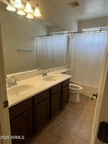 a bathroom with a glass shower door and sink