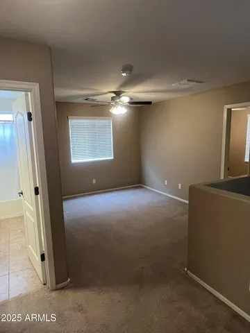 an empty room with closet and a bathroom