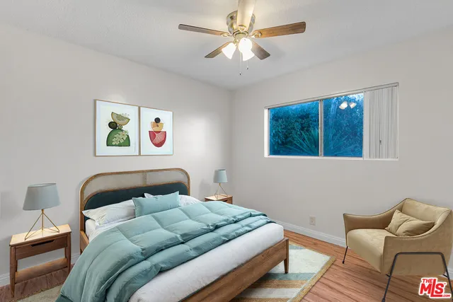 a bedroom with a bed couch and window