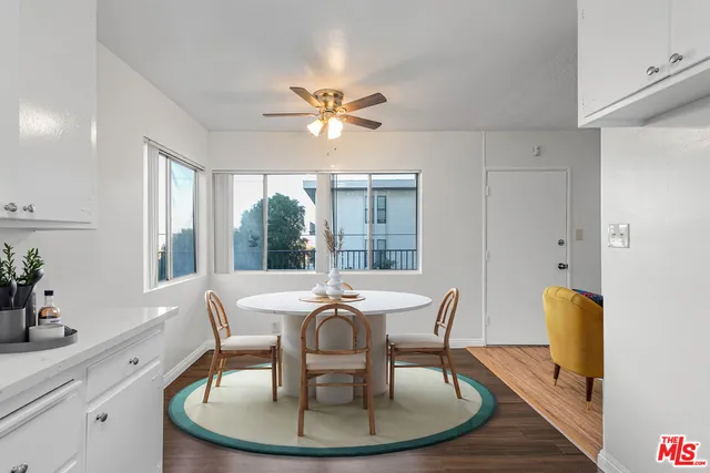 a dining room with furniture a chandelier and wooden floor