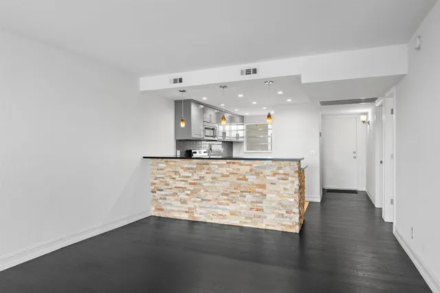 a view of kitchen with cabinets and wooden floor