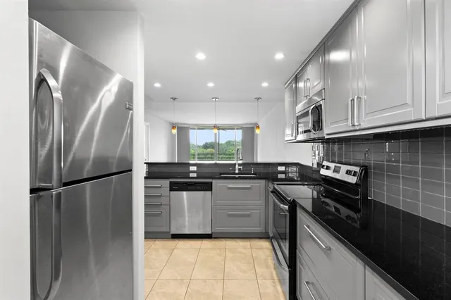 a kitchen with a sink stainless steel appliances and cabinets