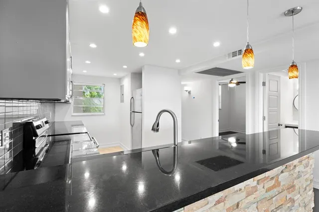 a kitchen with a sink appliances and a counter top space