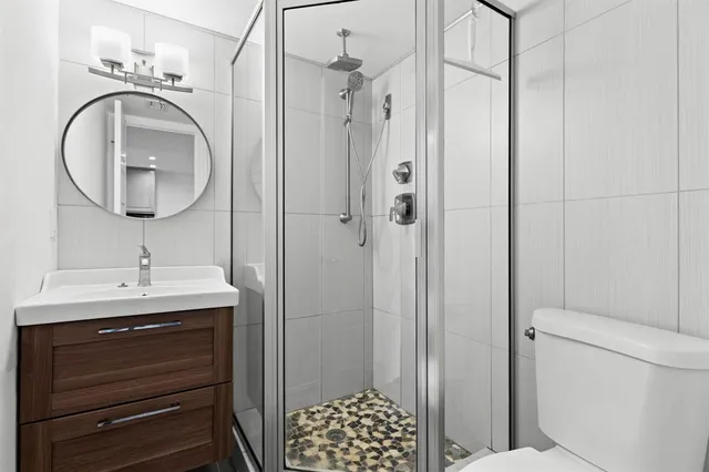 a bathroom with a sink a mirror and a shower