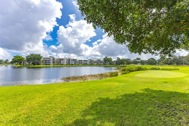 a view of a lake with houses in the back