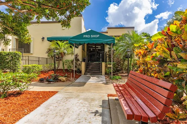a front view of a house with garden and seating area